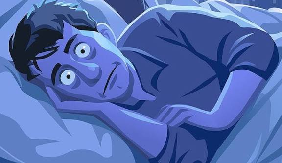 Person struggling to sleep, waking up at 3 AM